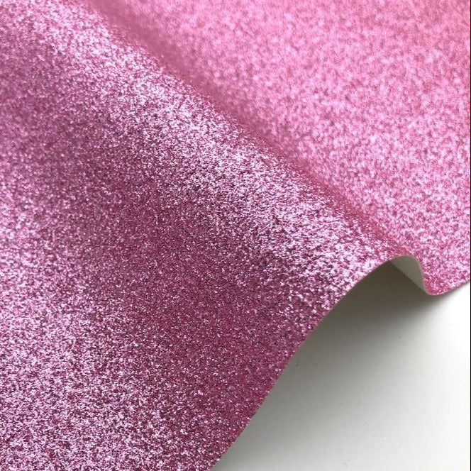 Close-up of pink glittery fabric on a white background